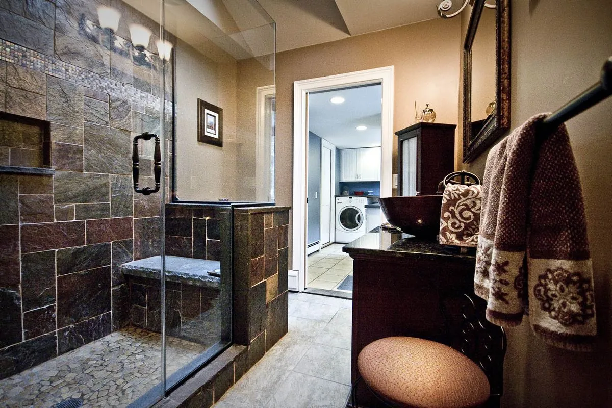 Bathroom with a tiled walk-in shower and frameless glass door