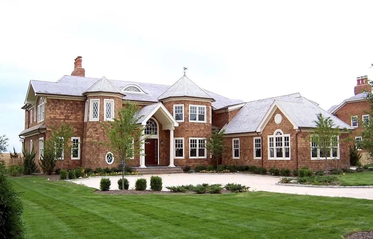 Brick home with a gabled roofline and front lawn