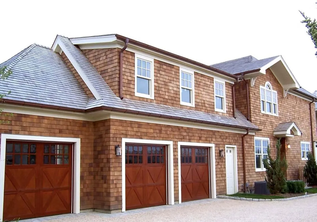 Shingle-sided home with a three-car garage and carriage-style doors