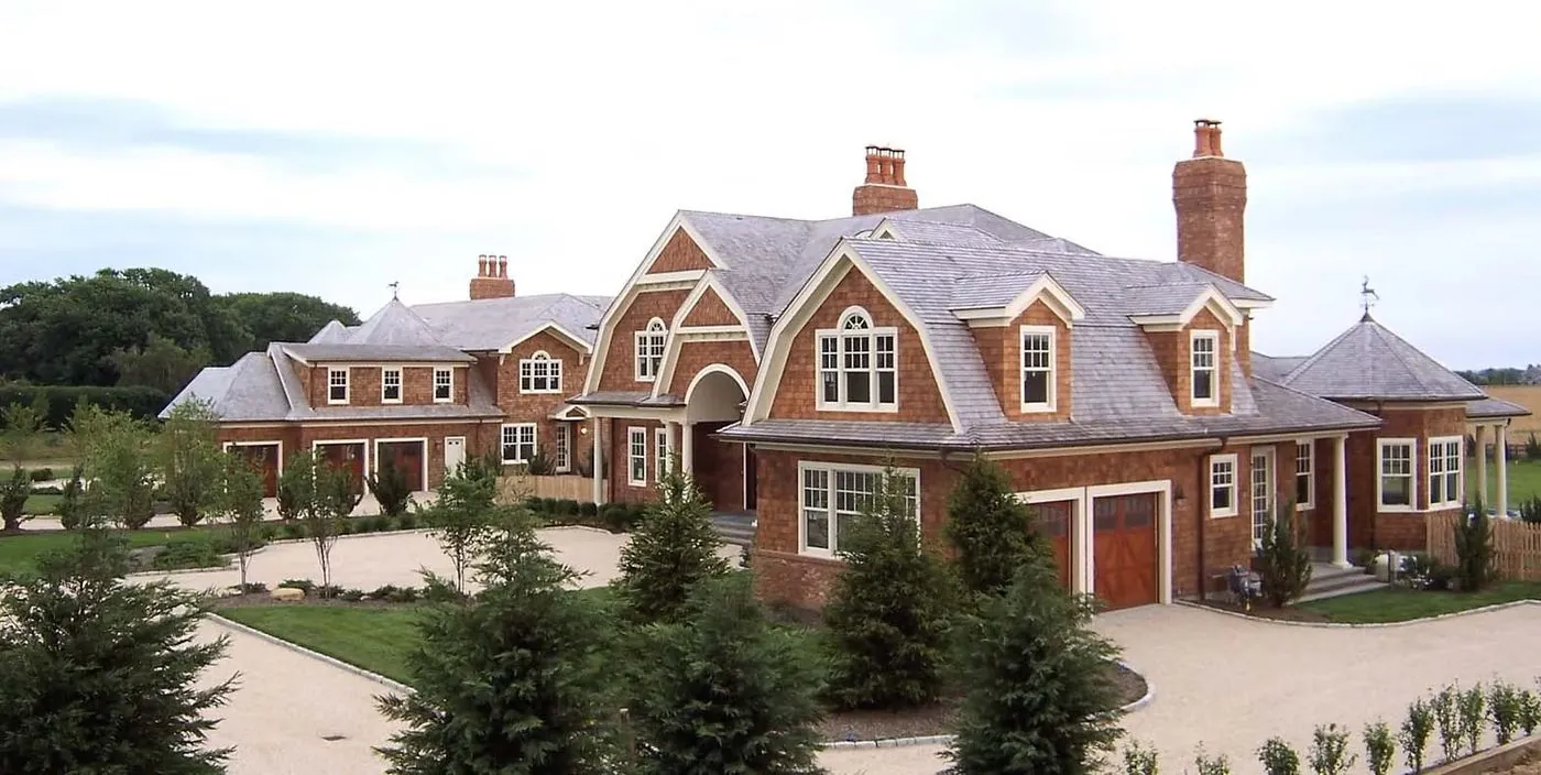 Large brick home with multiple gables and an attached garage
