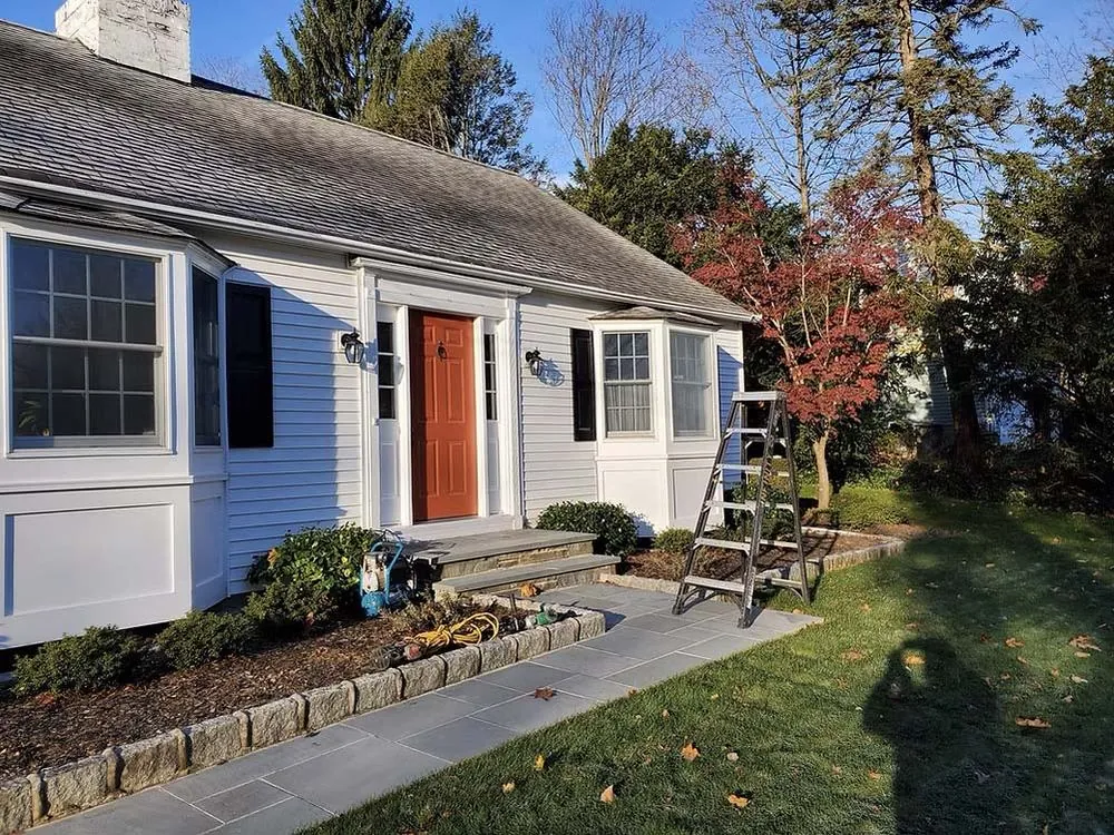 Freshly painted house exterior with a red entry door