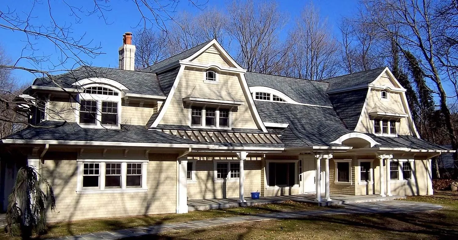 Cedar shingle home with a gambrel roof and shed dormers