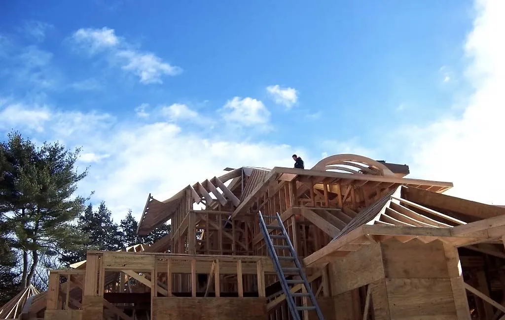 Carpenter framing a curved wooden roof