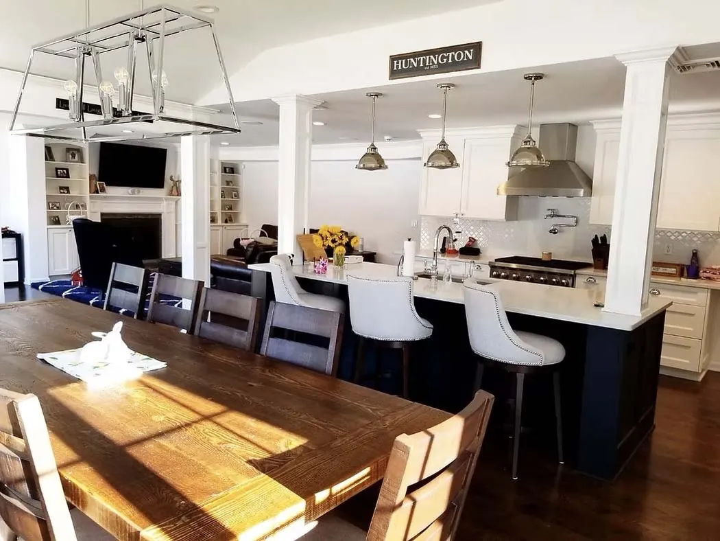 Kitchen remodel with island, white cabinets, and dining area